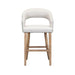 The Willow Counter Stool features a modern curved, upholstered white seat and backrest, supported by four light wood legs with horizontal supports for added stability.