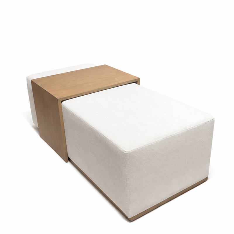 The Todi Rectangle Footstool & Coffee Table features a large white upholstered cushion with a rectangular wooden tray, offering a modern, versatile coffee table alternative against a crisp white backdrop.