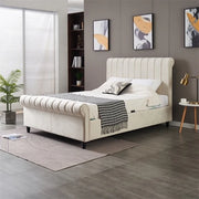 A modern bedroom featuring the Ascot Storage Bedframe in cream velvet, black-and-white blanket, decorative pillows, gray accent wall, abstract art, potted plant, small side table with lamp, and a window with blinds.