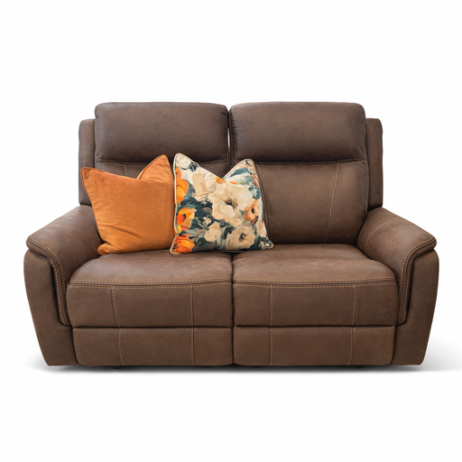 The Logan Recliner, upholstered in brown leather and as comfortable as a microfiber sofa, features two orange and floral-patterned throw pillows on its seat, set against a white background.
