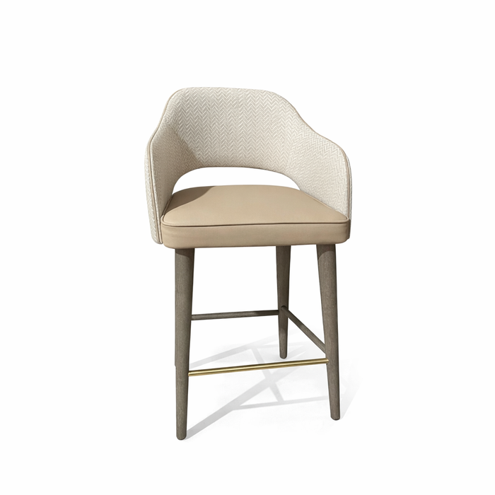 The Turim Counter Stool features a beige curved woven backrest, cushioned tan seat, wooden legs, and a gold metal footrest, displayed against a white background.
