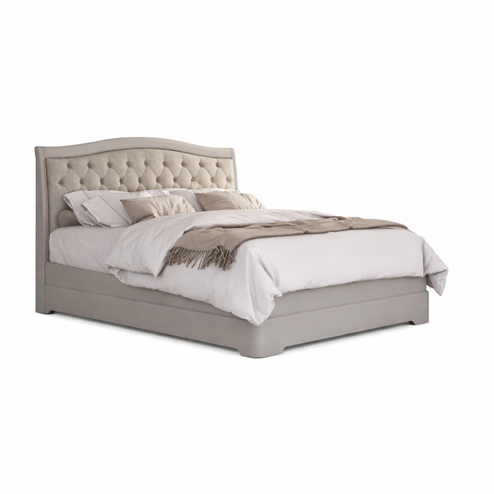 The Mabel Bedframe showcases a light gray upholstered headboard and wooden frame, styled with white bedding, beige pillows, and a beige throw blanket, all isolated on a white background.