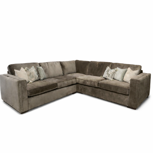The Ariya is a spacious L-shaped corner sofa for your living room, featuring wide arms, deep seats, brown fabric upholstery, and neutral-tone decorative throw pillows for maximum comfort.