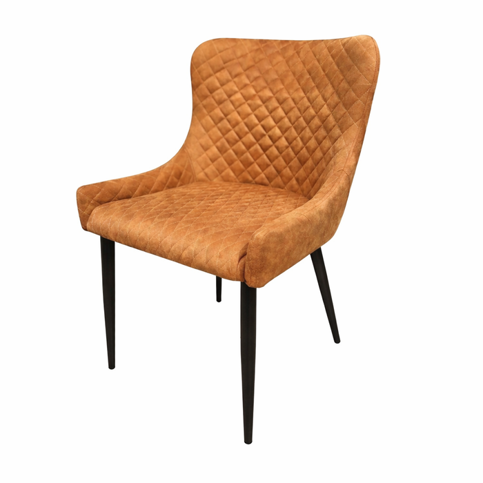 The Diamond Dining Chair features a cushioned, diamond-quilted tan seat and backrest with slim black legs, plus a slightly curved back and sides for enhanced comfort.
