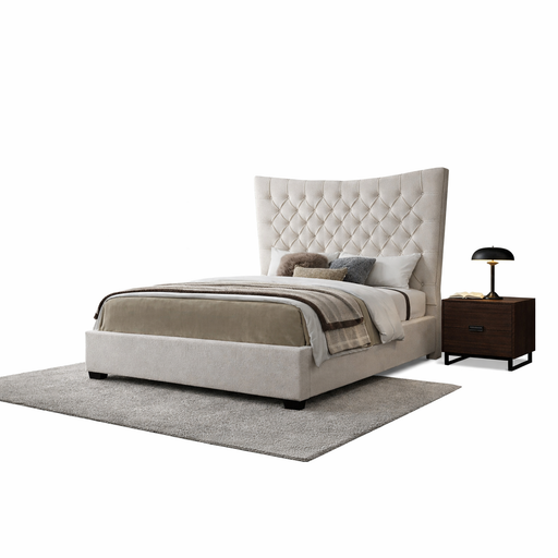 A modern bedroom setup featuring the Montreal Bedframe with a tall, beige upholstered headboard, assorted pillows, a brown blanket, gray rug, dark wooden nightstand, and black table lamp highlights luxury and elegance.
