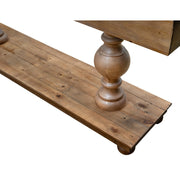 Close-up of the Leeds Console Table’s wooden leg with a turned, rounded design. Made from reclaimed pine, it features rustic charm with a plank tabletop and base, visible grain and knots, all isolated on a white background.