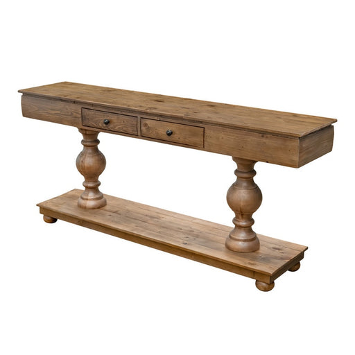 The Leeds Console Table features two small drawers, decorative turned legs, and a lower shelf, all crafted from reclaimed pine with a distressed finish. Its rustic design adds timeless style against a plain white background.