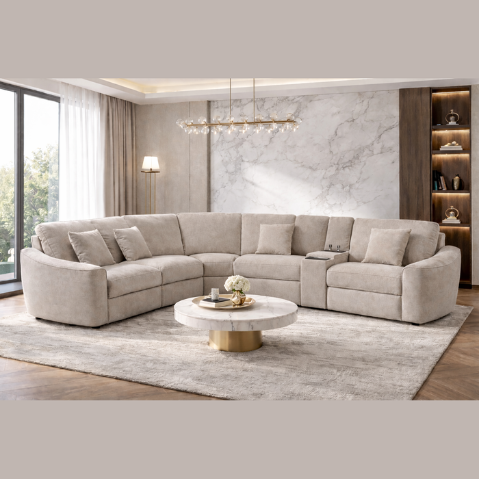 A modern living room featuring the Velora Corner Group sectional in beige chenille, a marble coffee table with gold base, light gray rug, floor lamp, wooden built-in shelves, and large windows that let in natural light.