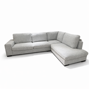The Sorrento Chaise Corner - Special Offer is a modern L-shaped sofa with neutral textured fabric upholstery, three seat cushions, and wide armrests, shown against a plain white background.
