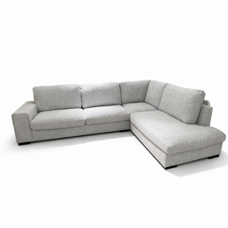 The Sorrento Chaise Corner - Special Offer is a modern L-shaped sofa with neutral textured fabric upholstery, three seat cushions, and wide armrests, shown against a plain white background.