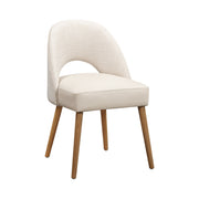 The Florence Dining Chair boasts light beige upholstery, an open lower backrest, and four wooden legs, making it a stylish modern addition to any contemporary space. Displayed on a plain white background.