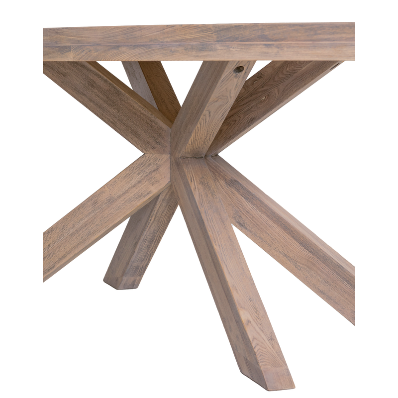 A close-up view of the Falun Oval Table, featuring a thick solid oak top and distinctive X-shaped legs, highlights its sturdy and modern design against a white background.