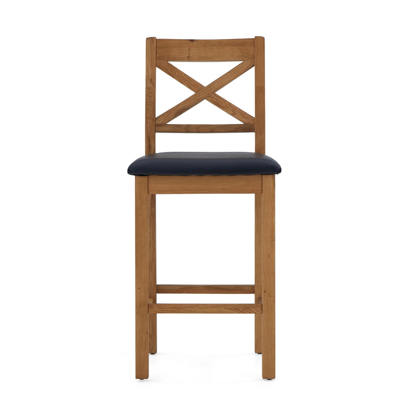 The Salisbury Barstool features a cross-back wooden design, rustic knotty White oak construction, and a black cushioned seat, shown here against a white background.