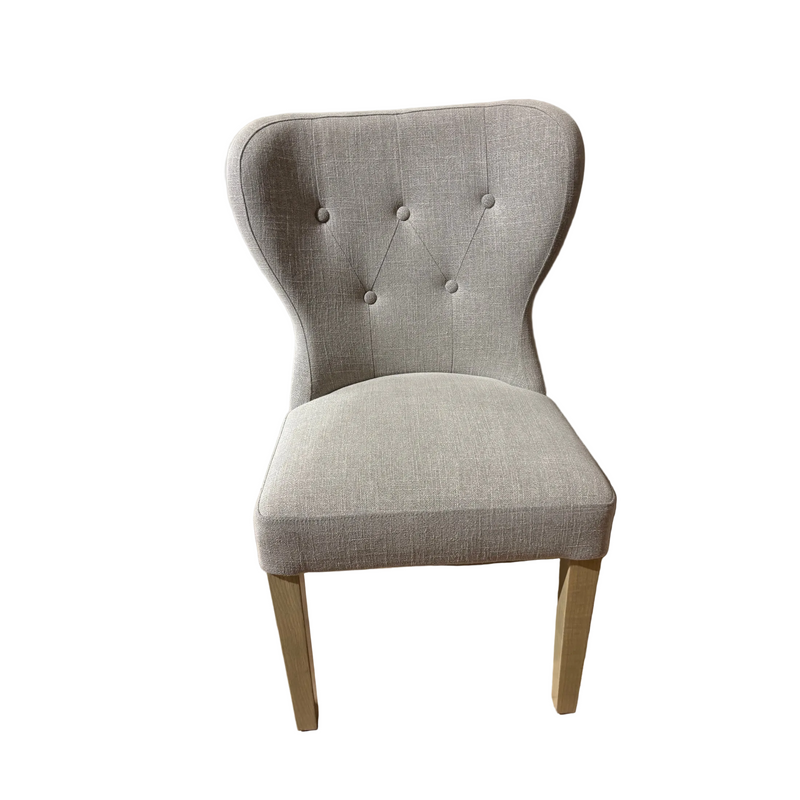 The Jacob chair features aqua clean upholstery, a button-tufted backrest, and light grey washed wood legs. Shown from the front against a white background.