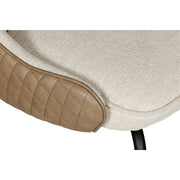 Close-up of the Sadia Dining Chair’s seat with light beige chenille fabric, tan quilted faux leather trim, and a black metal leg.
