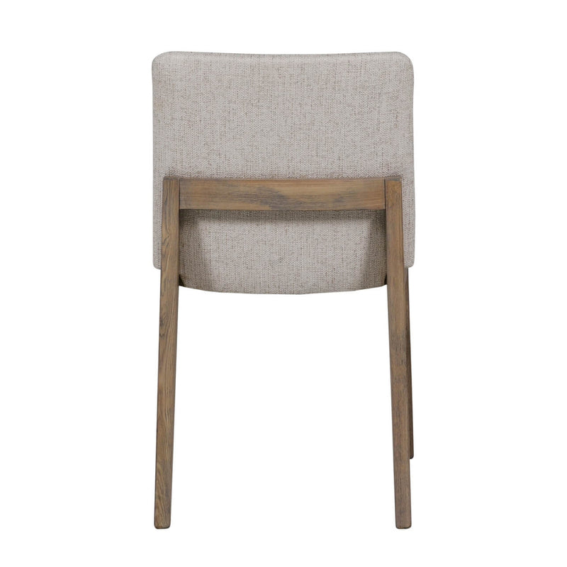 The Falun Dining Chair features a beige fabric seat, solid oak legs, and a rectangular backrest. Shown from the back, its straight wooden legs create a sleek, modern look.