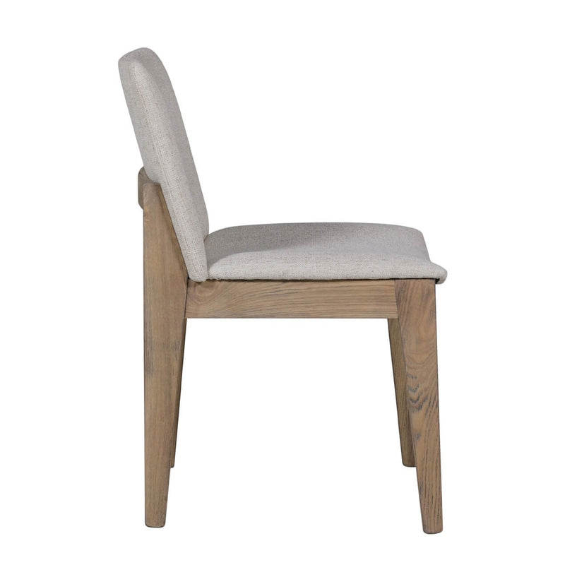 A side view of the Falun Dining Chair, featuring a light gray fabric seat and backrest, supported by a solid oak frame and legs with a natural finish.