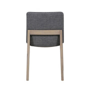 Back view of the Falun Dining Chair, featuring solid oak legs and a rectangular, dark gray upholstered backrest, shown against a white background.