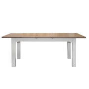 Two-tone wooden dining table with a visible extension leaf seam and painted base.