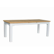The Eden dining table features a rectangular, small extendable design with a washed natural oak top and white legs, displayed against a plain white background.