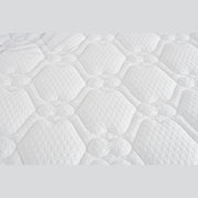 Close-up of the King Koil Paradise Mattress surface, featuring a soft, padded white fabric with a quilted hexagon and circle pattern. Flex-edge border supports and detailed stitching enhance comfort, support, and varied texture.