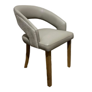 The Willow Dining Chair has a curved open-back design, upholstered in light gray leather with textured fabric on the backrest, and stands on four wooden legs—a stylish, modern choice for any contemporary dining space.