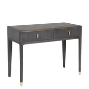 The Diletta Dressing Table features a sleek, modern design with dark wood, gold accents, slim tapered legs, ribbed front detailing, and two central drawers with gold handles—an ideal choice for stylish bedroom storage.