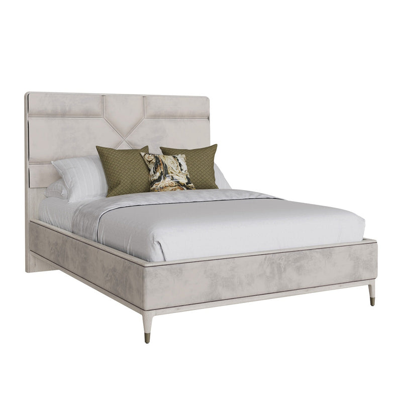The Diletta Bedframe is a modern queen-size bed with a tall, light gray upholstered headboard, white bedding, green animal-print accent pillows, and elegant ebony wood accents set against a white backdrop.