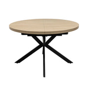 The Dalton 1.2 Round Extending Table features a light wood finish, a central split for extension, and intersecting black metal legs, set against a plain white background.
