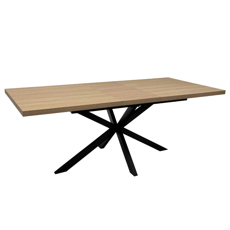 The Dalton 1.6 Extending Table features a light wood-effect rectangular tabletop and a modern black metal base with intersecting angled legs, offering a sleek industrial style.