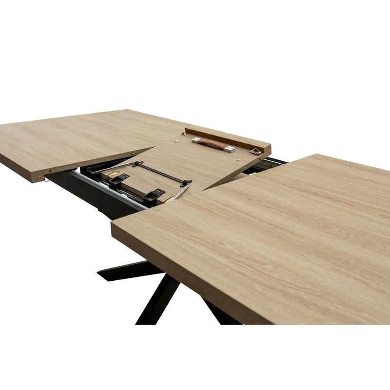 The Dalton 1.6 Extending Table features a light wood-effect top with sleek black legs and reveals its extension leaf and metal sliding mechanism in the center when partially open, highlighting its industrial style.