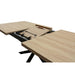The Dalton 1.6 Extending Table features a light wood-effect top with sleek black legs and reveals its extension leaf and metal sliding mechanism in the center when partially open, highlighting its industrial style.