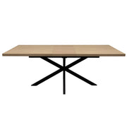 The Dalton 1.6 Extending Table features a rectangular wood-effect top and a black metal X-shaped base in an industrial style, presented against a white background.