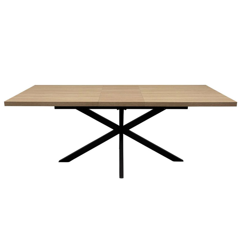 The Dalton 1.6 Extending Table features a rectangular wood-effect top and a black metal X-shaped base in an industrial style, presented against a white background.