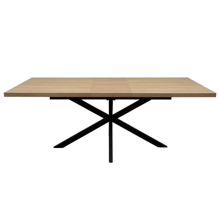 The Dalton 1.6 Extending Table features a rectangular wood-effect top and a black metal X-shaped base in an industrial style, presented against a white background.