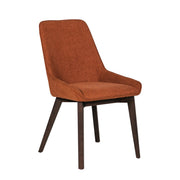The Axton Dining Chair features an orange upholstered seat and backrest, four dark wooden legs, and a sleek, minimalist design—ideal for pairing with dining chairs around the Ariya table.