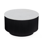 The Lucas Round Coffee Table features a white marble top and a black, vertically grooved cylindrical base.
