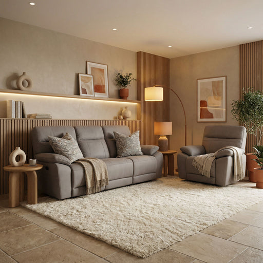 Modern living room with beige walls, neutral decor, a contemporary sofa and Jude Recliner Sofa in washable microfiber, soft pillows, cozy throws, plush rug, wooden side tables, plants, abstract wall art, and gentle lamp and recessed lighting.