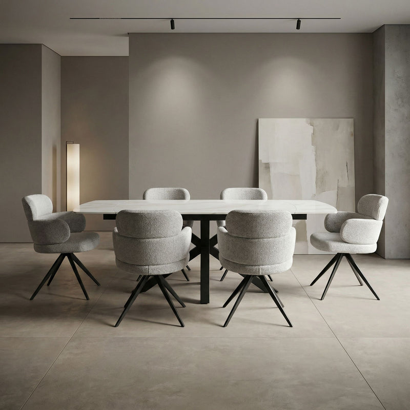 A minimalist dining room showcases the Positano Table with six Orbit Chairs in grey upholstery and black legs, complemented by neutral walls, soft lighting, and abstract artwork for an elegant, serene ambiance.