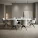 A minimalist dining room showcases the Positano Table with six Orbit Chairs in grey upholstery and black legs, complemented by neutral walls, soft lighting, and abstract artwork for an elegant, serene ambiance.