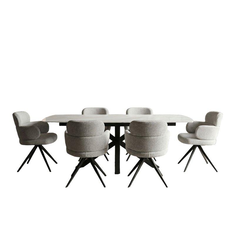 The Positano Table + 6 Orbit Chairs features a sleek sintered stone rectangular table and six cushioned light gray chairs with black angled metal legs, all styled minimally against a white background.