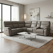 A modern living room featuring the Jude Corner Sofa in gray, a light gray area rug, white coffee table, hardwood floors, large windows with sheer curtains, and abstract wall art.