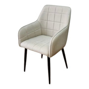 The Bianco dining chair features cream quilted faux leather upholstery and four slender black legs, presented against a plain white background.