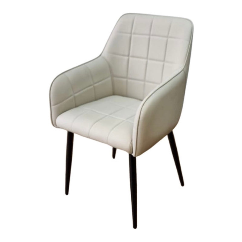 The Bianco dining chair features cream quilted faux leather upholstery and four slender black legs, presented against a plain white background.