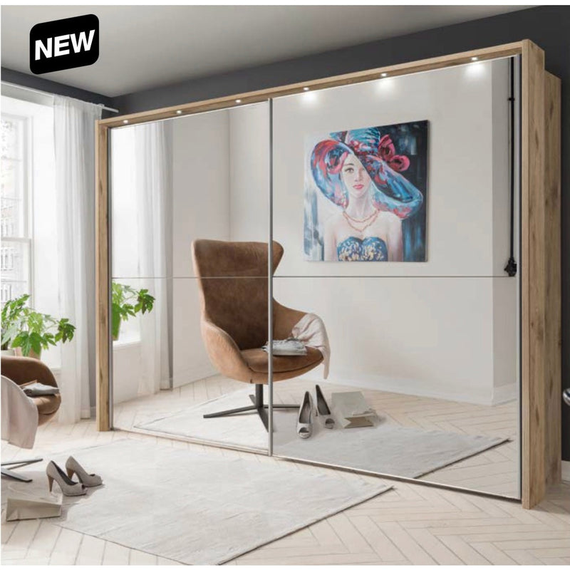 A modern room featuring the new Berlin Sliderobe, a brown swivel chair, shoes on the floor, white curtains, a green plant, and a colorful portrait of a woman on the wall. "NEW" label in the top left corner.