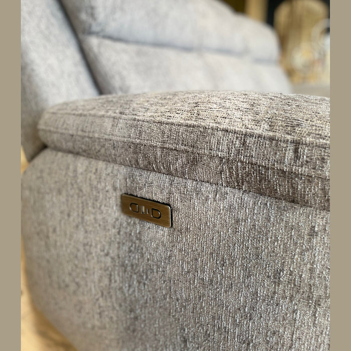 Close-up of the Elenor Electric Reclining Range, highlighting its modern grey fabric, textured upholstery, and sleek metallic electric recline controls. A softly blurred background enhances its contemporary appeal.