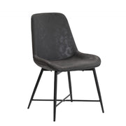 An industrial dining chair with black powder-coated steel legs and upholstered in soft faux leather, featuring a high back and bucket seat design.