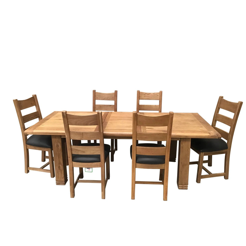 A set of six wooden dining chairs with upholstered seats, surrounding a large rectangular extending dining table made of solid oak.