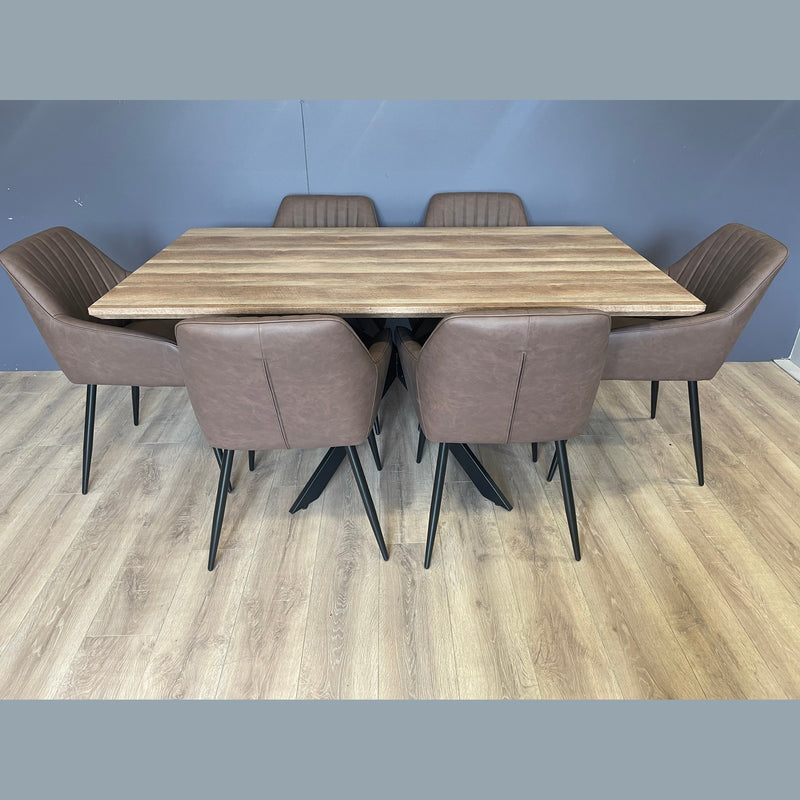 The Elson 1.6 Dining Table features black X legs and a rectangular wooden top, paired with six brown cushioned chairs on a light wood floor, set against a plain gray wall.