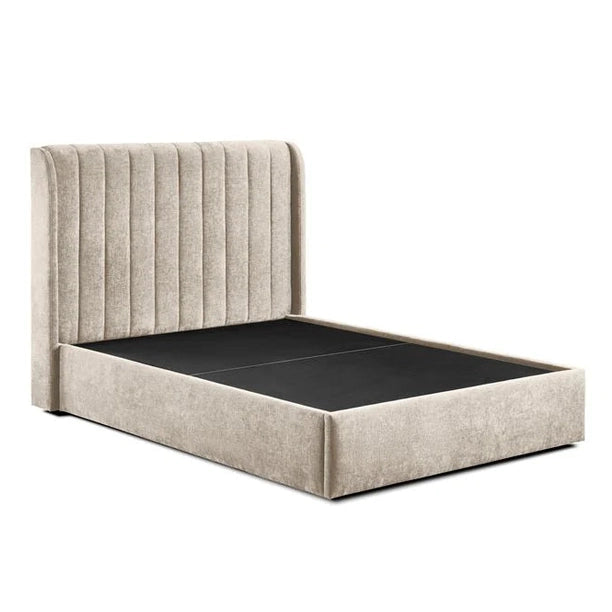 The Frida Storage Bed features a beige upholstered frame, a tall vertically channeled headboard, and a platform base with under-bed storage for convenience. Shown without mattress.